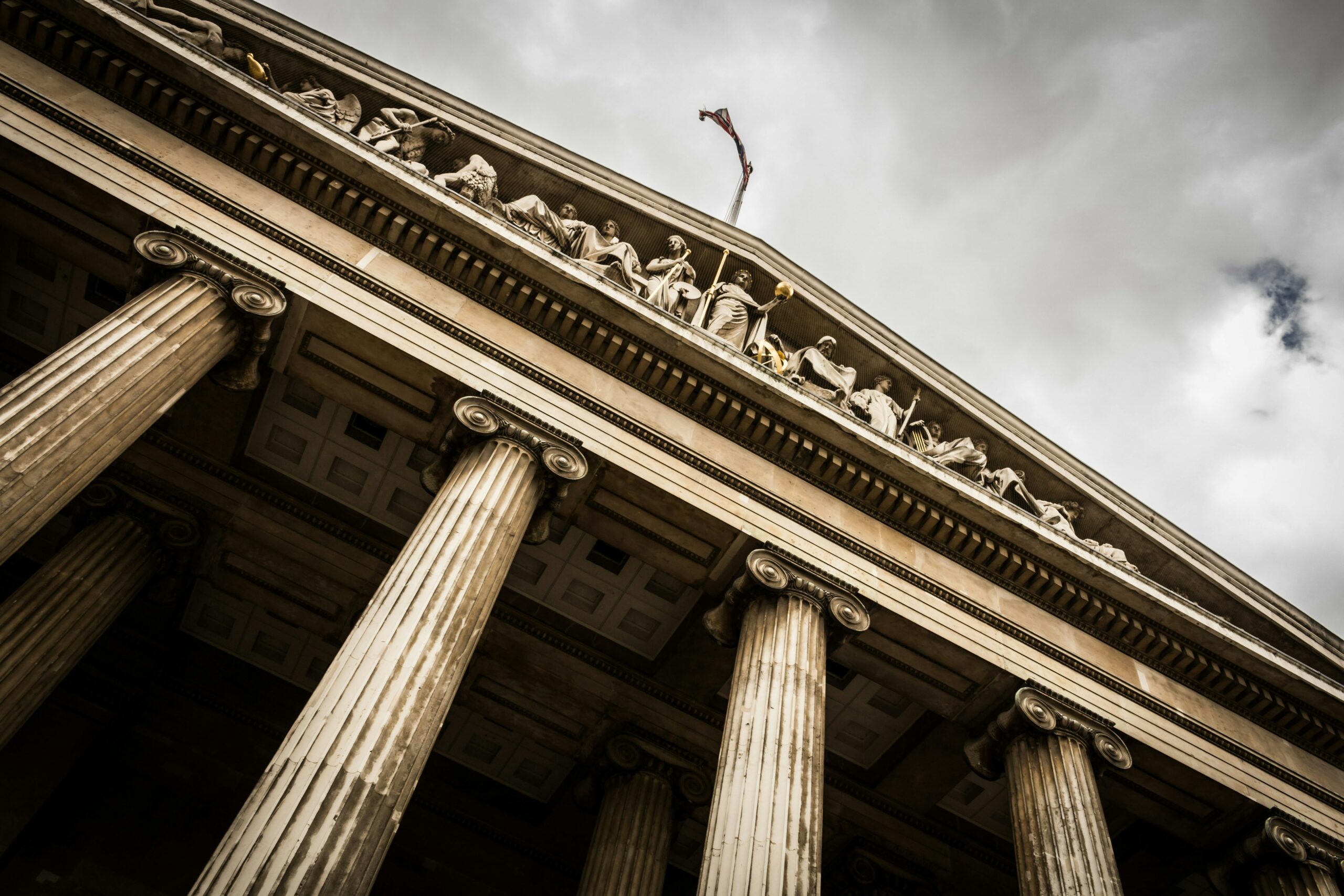 Looking up at court building with cloudy sky in the background